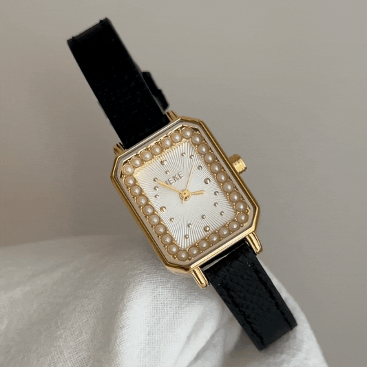 Noir Elegance – Black Leather Strap Women’s Quartz Watch with Gold Rectangular Case and Pearl Crystal Bezel