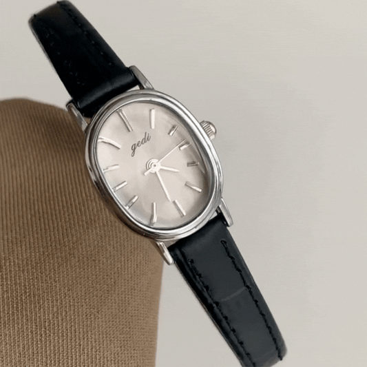 Vintage Chic: Oval Silver Case & Black Leather Quartz Watch