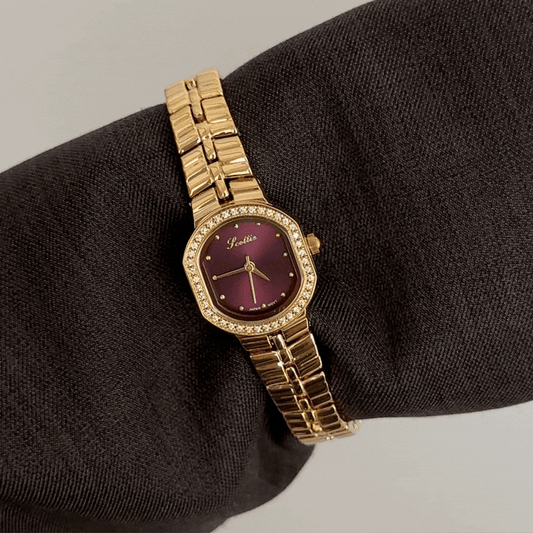 Feminine Luxury: Red Round Dial Watch with Gold Diamond Bezel & Stainless Steel Bracelet