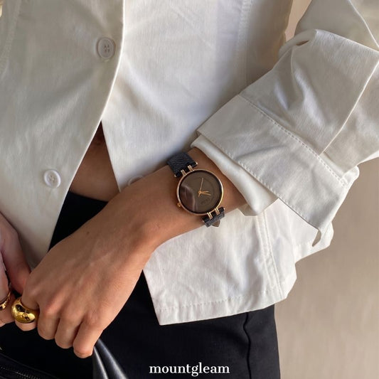 Timeless Contrast: Black Round Dial Watch with Gold Bezel & Black Leather Strap