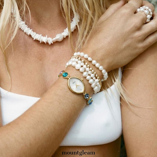 Rainbow Radiance：White Almond-Shaped Dial Watch with Gold Bezel & Multi-Color Crystal-Studded Stainless Steel Bracelet
