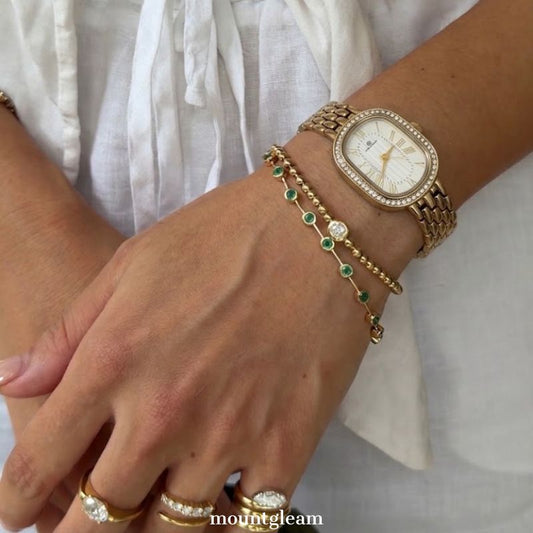 Luxurious Glamour: White Oval Dial Watch with Gold Diamond Bezel & Steel Bracelet