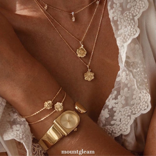 Statement Boldness: Luxurious Gold Round Dial Watch with Gold Cuff Bracelet