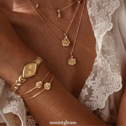 Modern Luxe: Gold Elongated Rhombus Dial Watch with Gold-Tone Leaf-Design Bracelet