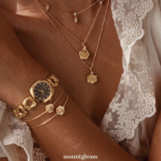 Geometric Contrast: Black Round Dial Watch with Gold Oval Bezel & Irregular Gold Bracelet