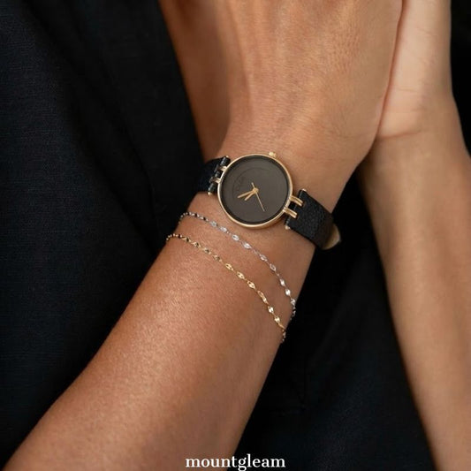 Timeless Contrast: Black Round Dial Watch with Gold Bezel & Black Leather Strap
