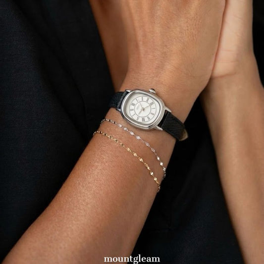 Retro Chic: Silver Oval Watch with Pristine White Dial & Black Leather Strap