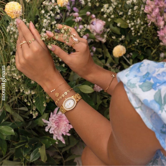 Gilded Grace: White Oval Dial Watch with Gold Diamond Bezel & Alloy Bracelet