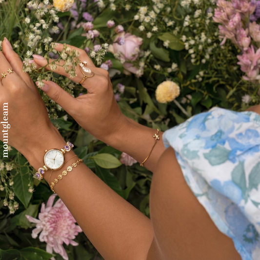 Gilded Elegance: White Round Dial Watch with Gold Bezel & Purple Gemstone-Set Gold Bracelet