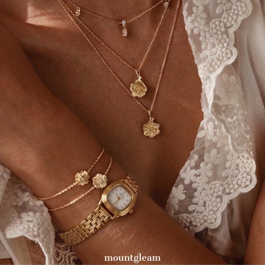 Feminine Shine: A Gilded Oval Statement – White Dial, Gold Bezel & Matching Steel Bracelet