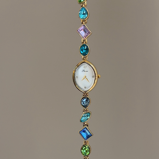 Rainbow Radiance：White Almond-Shaped Dial Watch with Gold Bezel & Multi-Color Crystal-Studded Stainless Steel Bracelet