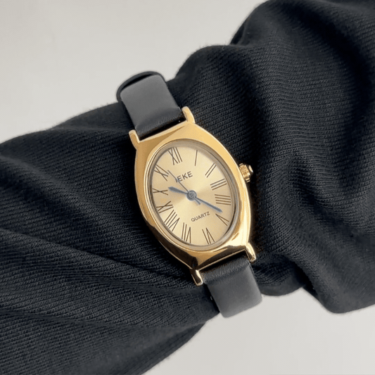 Executive Grace: Gold Oval Watch with Polished Gold Bezel & Black Leather Strap