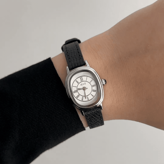 Retro Chic: Silver Oval Watch with Pristine White Dial & Black Leather Strap