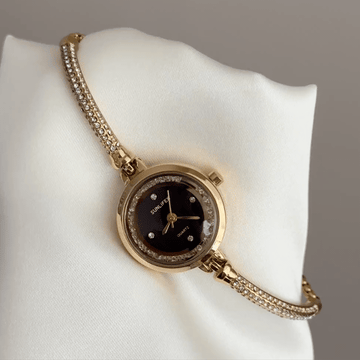 Expandable Ease: Black Round Dial Watch with Gold Bezel & Gold Expandable Chain Bracelet