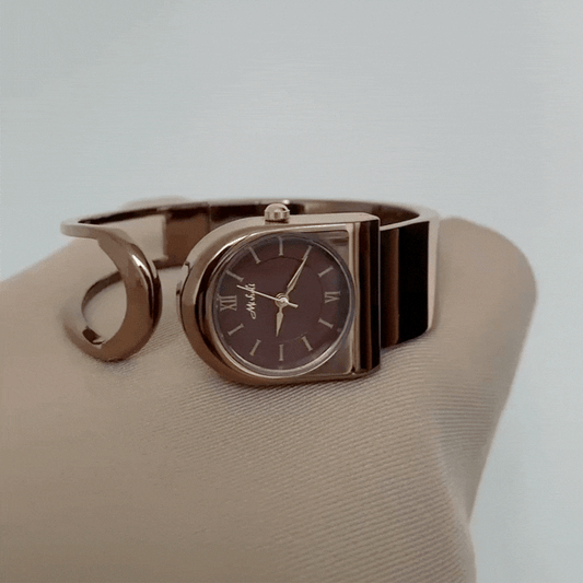 Monochrom Vintage: Braune runde Zifferblattuhr mit braunem Edelstahl-Armband