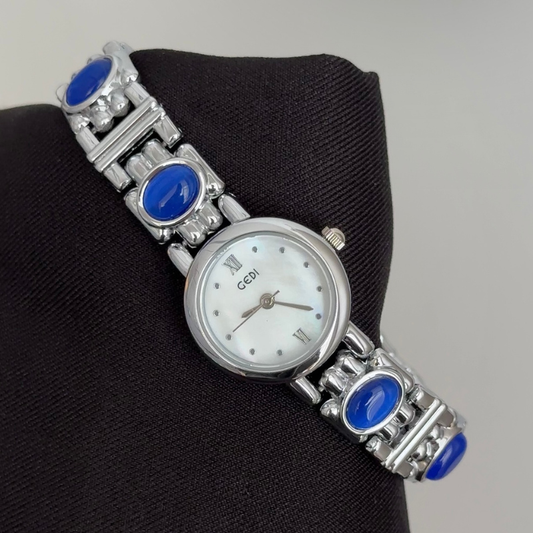 Chic Grace Elegant: White Mother-of-Pearl Round Dial Watch with Silver Bezel & Blue Gemstone Alloy Bracelet