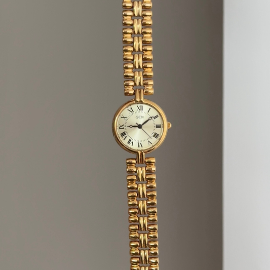 Warm Radiance: Gold Round Dial Watch with Gold Bezel & Gold Alloy Bracelet