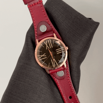 Bold Contrast: Black Round Dial with Rose Gold Bezel & Red Strap