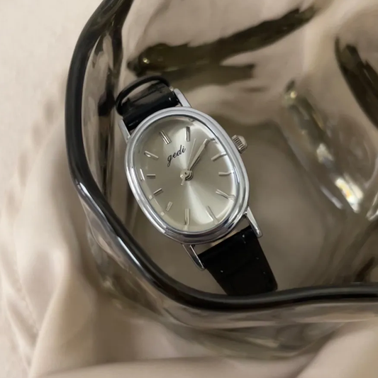 Vintage Chic: Oval Silver Case & Black Leather Quartz Watch