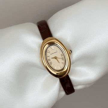 Retro Elegance: Gold Oval Dial Watch with Brown Leather Strap
