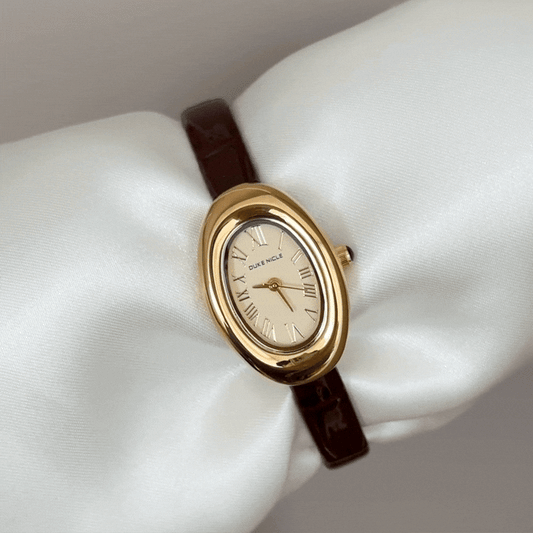 Retro Elegance: Gold Oval Dial Watch with Brown Leather Strap