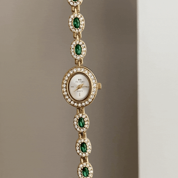 Glamour Elegant: White Oval Dial Watch with Gold Diamond Bezel & Emerald Gemstone Alloy Bracelet