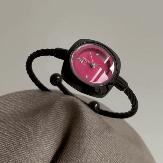 black bangle watch with red round dial