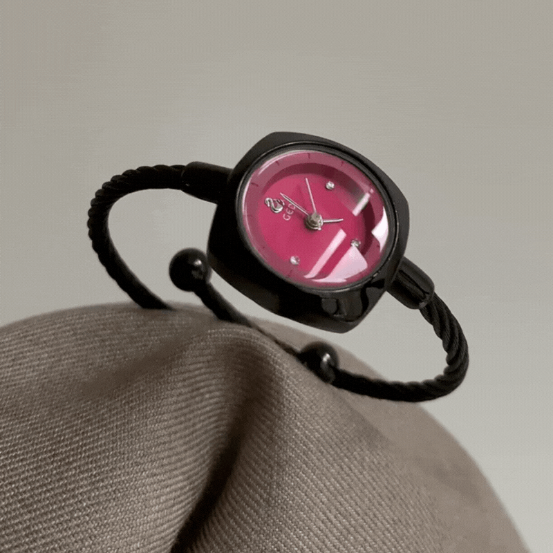 black bangle watch with red round dial