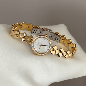 Diamond Sparkle: White Round Mother-of-Pearl Dial Watch with Gold Diamond Bezel & Gold Quilted Chain Bracelet
