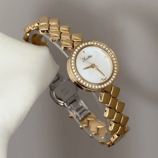 Diamond Sparkle: White Round Mother-of-Pearl Dial Watch with Gold Diamond Bezel & Gold Quilted Chain Bracelet