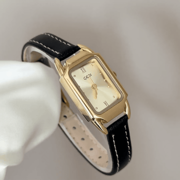 Modern Contrast: Gold Rectangular Dial Watch with Matching Bezel & Black Leather Strap