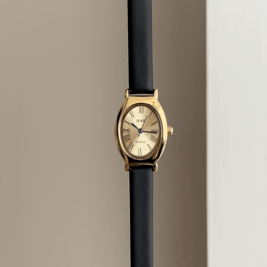 Executive Grace: Gold Oval Watch with Polished Gold Bezel & Black Leather Strap