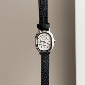 Retro Chic: Silver Oval Watch with Pristine White Dial & Black Leather Strap