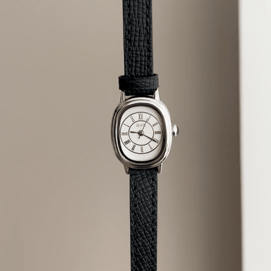 Retro Chic: Silver Oval Watch with Pristine White Dial & Black Leather Strap
