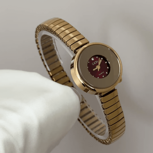 Expandable Comfort: Red Round Dial Watch with Gold Bezel & Expandable Steel Bracelet