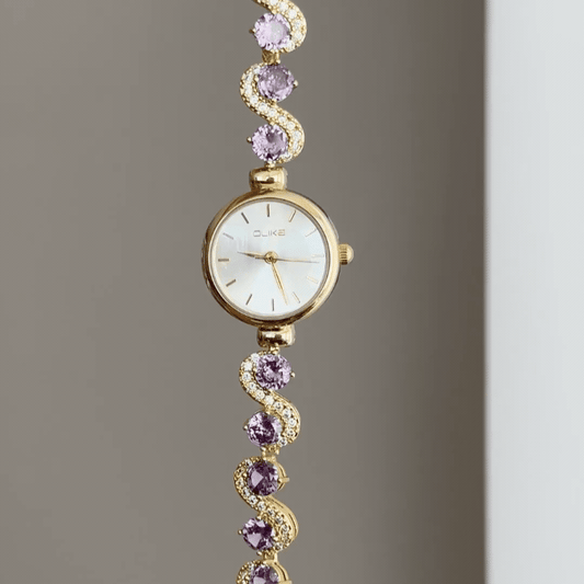 Gilded Elegance: White Round Dial Watch with Gold Bezel & Purple Gemstone-Set Gold Bracelet