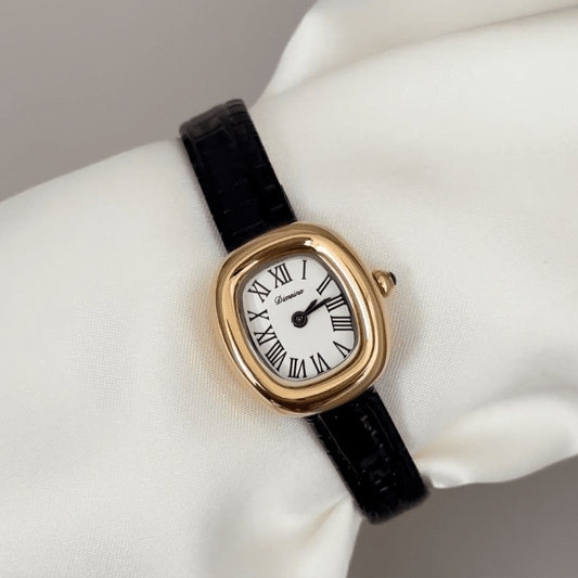 Feminine Luxury: White Oval Dial Watch with Gold Oval Bezel & Black Genuine Leather Strap