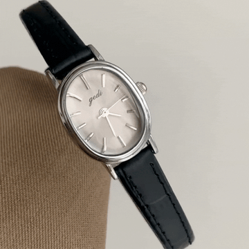 Vintage Chic: Oval Silver Case & Black Leather Quartz Watch