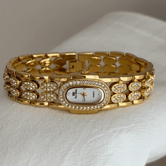 Gold Wide Strap Watch with Diamond-Accented Case & White Oval Dial – Women’s Quartz Watch