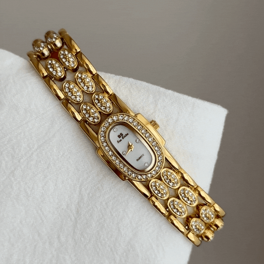 Gold Wide Strap Watch with Diamond-Accented Case & White Oval Dial – Women’s Quartz Watch