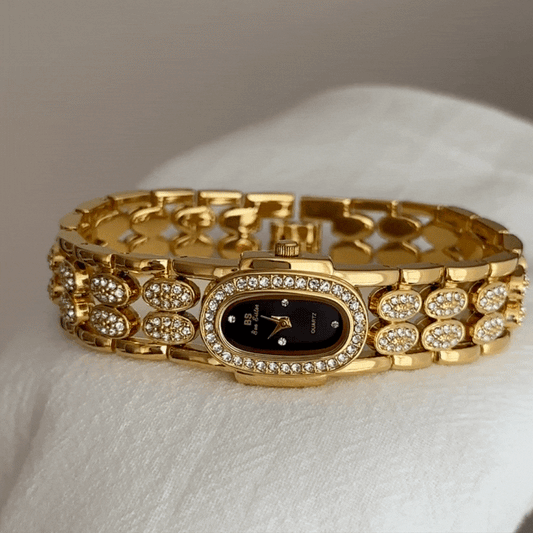 Gold Wide Strap Watch with Diamond-Accented Case & Black Oval Dial – Women’s Quartz Watch