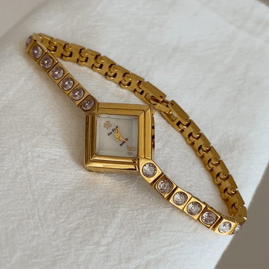 Elegant Gold Bracelet Watch with Pink Diamond Accents & White Rhombus Dial – Women’s Quartz Watch