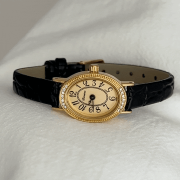 Elegant Fashion Black Leather Strap Women’s Quartz Watch with Oval Gold Diamond-Accented Dial