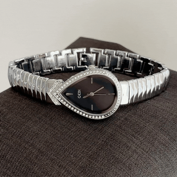 Bold Artistry: Black Teardrop Serpent-Head Dial with Silver Diamond Bezel & Strap