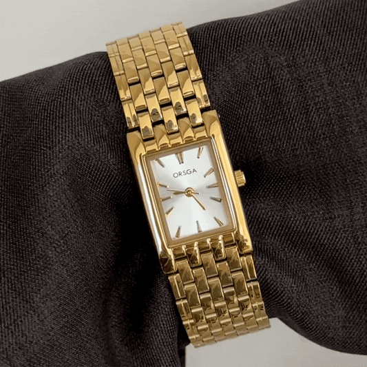Defining Luxury Minimalism: A White Rectangle Dial with Gold Bezel & Bracelet