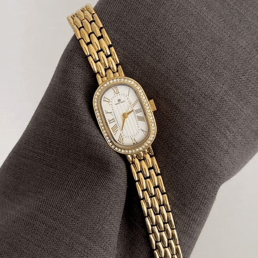 Luxurious Glamour: White Oval Dial Watch with Gold Diamond Bezel & Steel Bracelet
