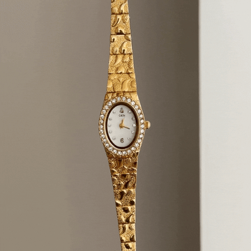 Gilded Grace: White Oval Dial Watch with Gold Diamond Bezel & Alloy Bracelet