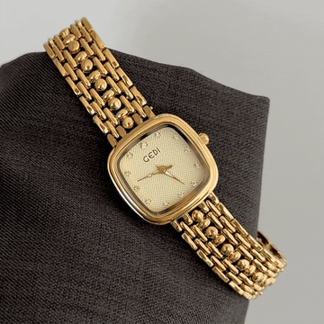 Manifesting Monochrome Luxury: A Gold Rectangle Dial with Matching Full Gold-Tone Bracelet