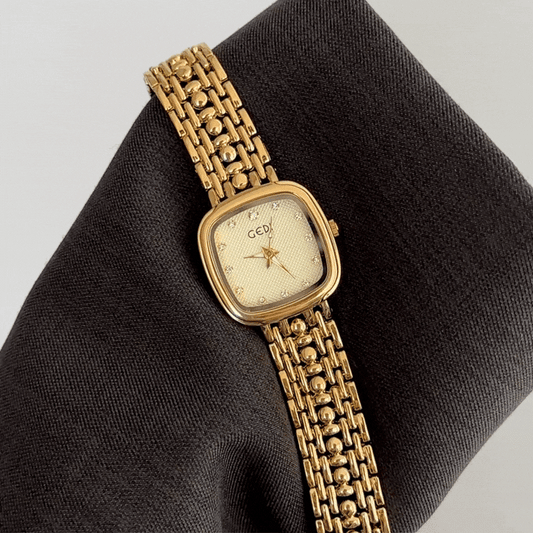 Manifesting Monochrome Luxury: A Gold Rectangle Dial with Matching Full Gold-Tone Bracelet