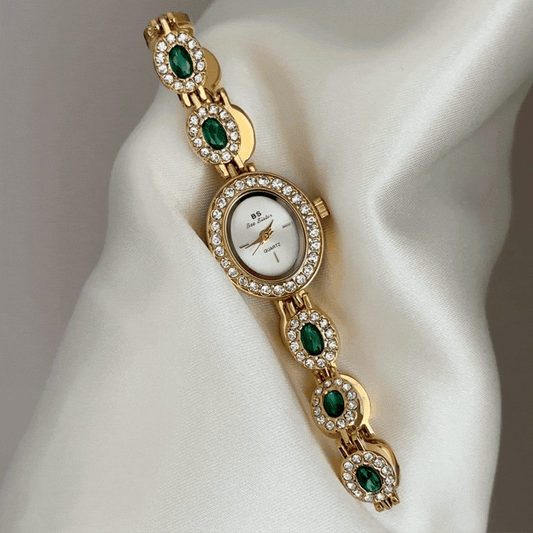 Glamour Elegant: White Oval Dial Watch with Gold Diamond Bezel & Emerald Gemstone Alloy Bracelet